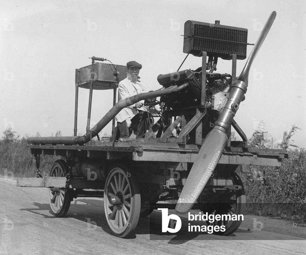 Inventor driving his car to helices.