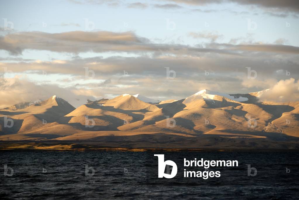 Dark waters of Lake Manasarovar; a sacred lake in front of the Gurla Mandhata mountain range with shadows; Himalayas; Western Tibet; Tibet Autonomous Region; People's Republic of China; Asia