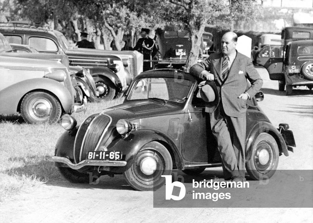 Around man has a small car.