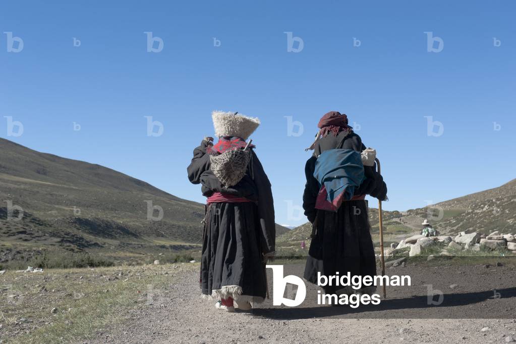 Tibetan Buddhist; pilgrims dressed in traditional costume near the Zutul Puk Gompa monastery; pilgrimage route around the sacred Mount Kailash; writing on rock; Gang Rinpoche; Kora; Ngari; Gang-Tise Mountains; Trans-Himalaya; Himalayan; West Tibet; Tibet Autonomous Region; People's Republic of China; Asia