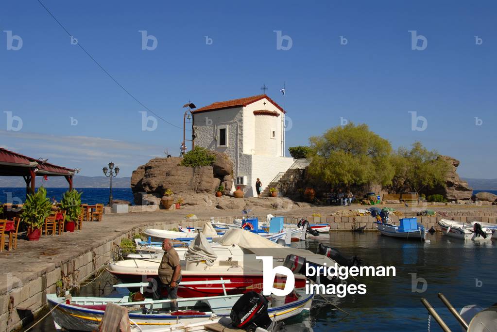 Greek Orthodox Christianity; small fishing boats in the harbor of Skala Sikaminea; chapel on rocks; Lesbos island; Aegean Sea; Greece; Europe