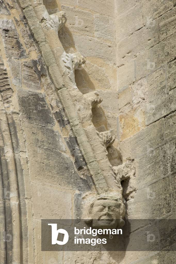 smiling head, south facade detail, cathedral of Saint Vincent de Bayeux