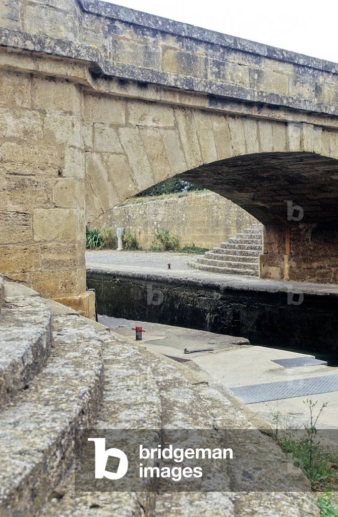 The Gaillousty lock on the Canal du Midi, France. Photography 2002. At 60 years old, under Louis XIV, engineer Pierre Paul Riquet embarks on an extraordinary adventure, connecting the Garonne to the Mediterranean with the technical and topographical means of the 18th century. The Midi Canal will take 15 years of work to dig and feed a 240 km long artificial stream.