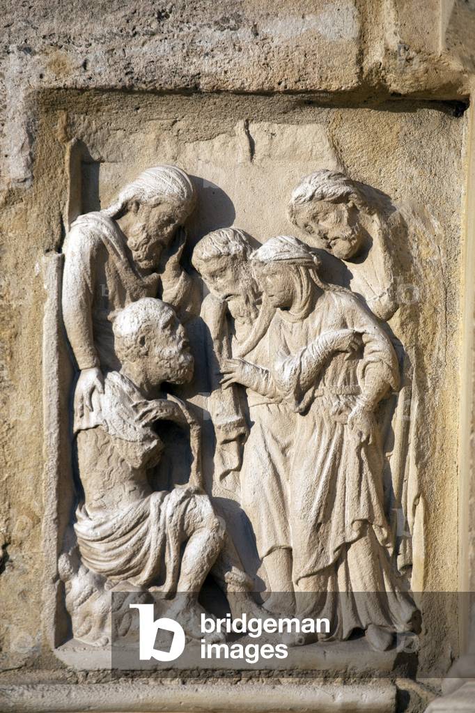 On the foothills surrounding the portal, four bas-reliefs from the 13th century represent biblical scenes. Here, Job on his manure, surrounds his wife and friends. Notre Dame de Paris Cathedrale Notre Dame de Paris - Paris 4 - XIIIth, XIIIth, XIXeme, rehabilitation by Viollet-le-Duc -
