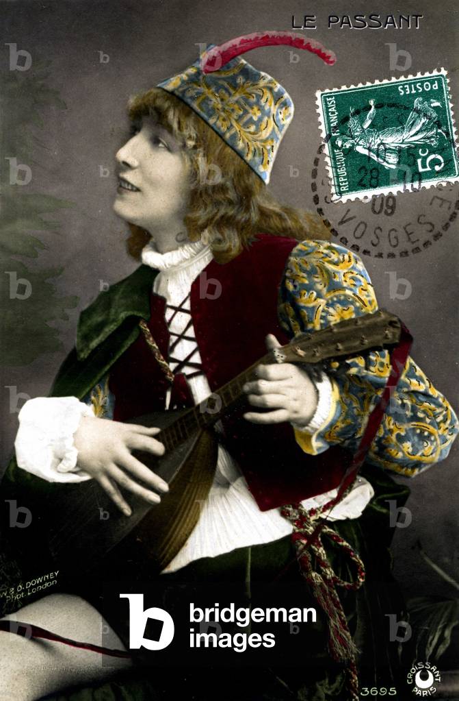 Portrait of Henriette Rosine Bernard dit Sarah Bernhardt (1844-1923), in the role of troubadour Zanetto, playing lute in François Coppée's play “” Le passer”. Photo W. & D. Downey. Postcard from the beginning of the 20th century.