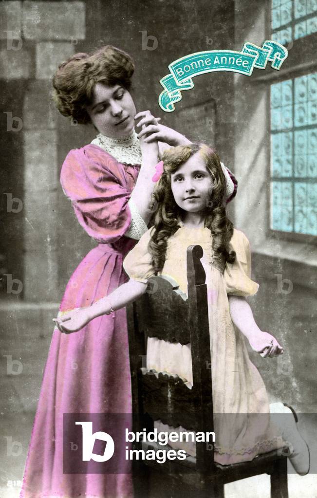 Two prayer positions: Mother praying with her hands joined with her daughter knees apart. Postcard for New Year's Greetings, circa 1920.