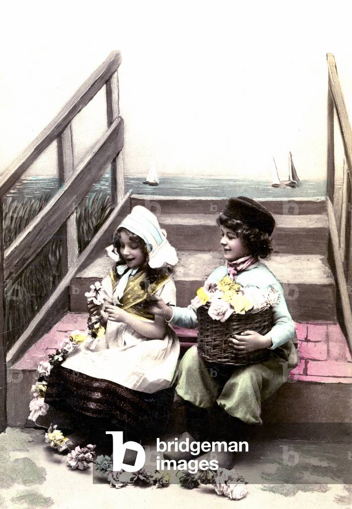 Two Dutch little children at the beach Postcard, 1920