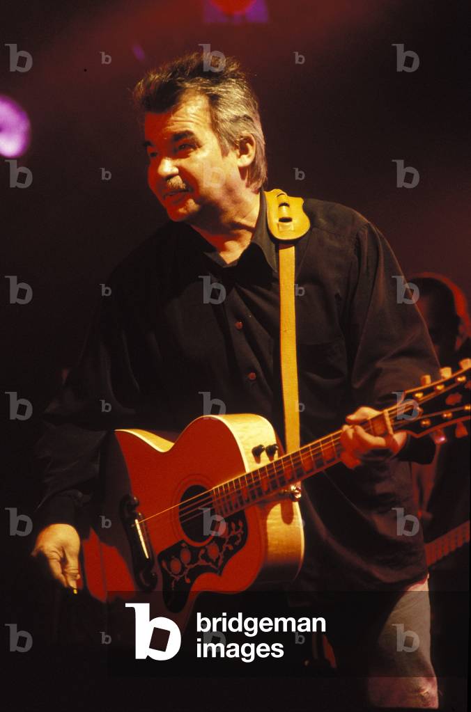 John Prine playing acoustic guitar at Fleadh 1996. American country singer. Folk music.