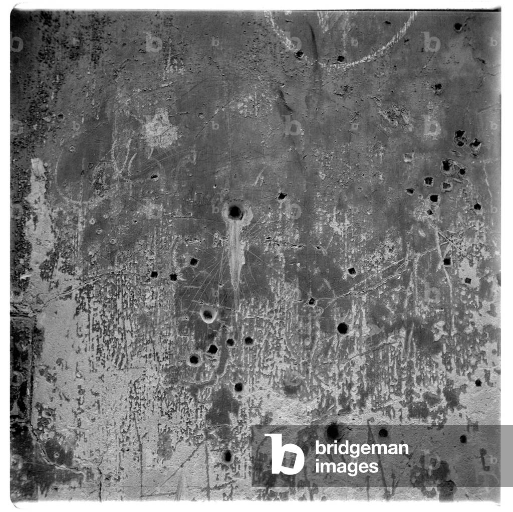 Image of a wall riddled with bullet holes, Paris, early early 1950's