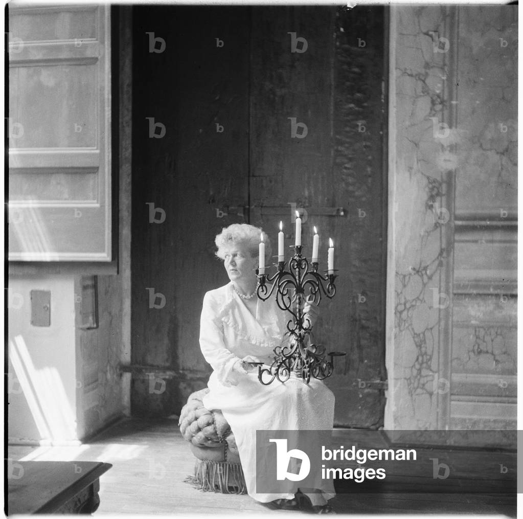 Caresse Crosby, portrait of American patron of the arts and inventer of first patented brassiere, in Castello di Rocca Sinibalda, Italy, mid 1950's (b/w photo)