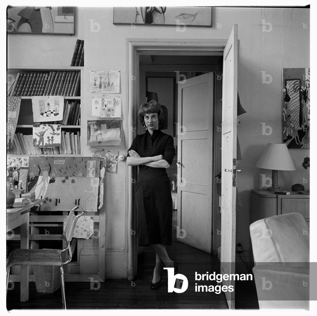 Pegeen Vail Guggenheim, portrait of Pegeen Guggenheim, daughter of Peggy Guggenheim, wife of situationist painter Ralph Rumney, step-daughter of Max Ernst, in her home in Paris, France mid 1950's (b/w photo)