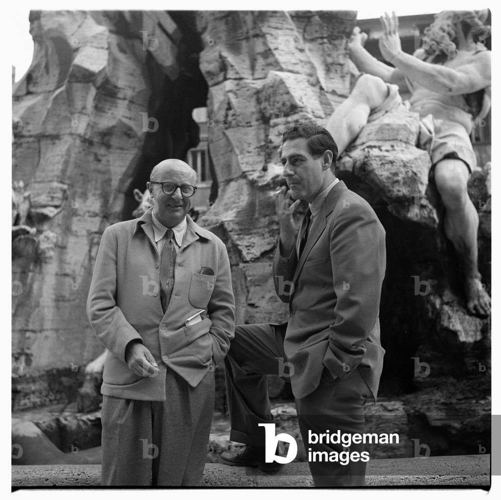 Portrait of two unknown men standing in front of the Fountain of the Four Rivers, Fontana dei Quattro Fiumi, Rome, Italy, early early 1950's