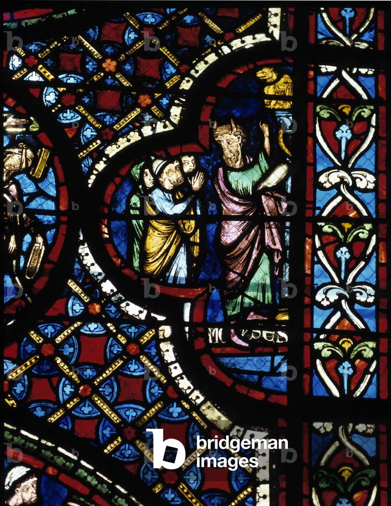 Moses places the brazen snake on a pole to protect anyone who has been bitten by a snake. Stained glass of the