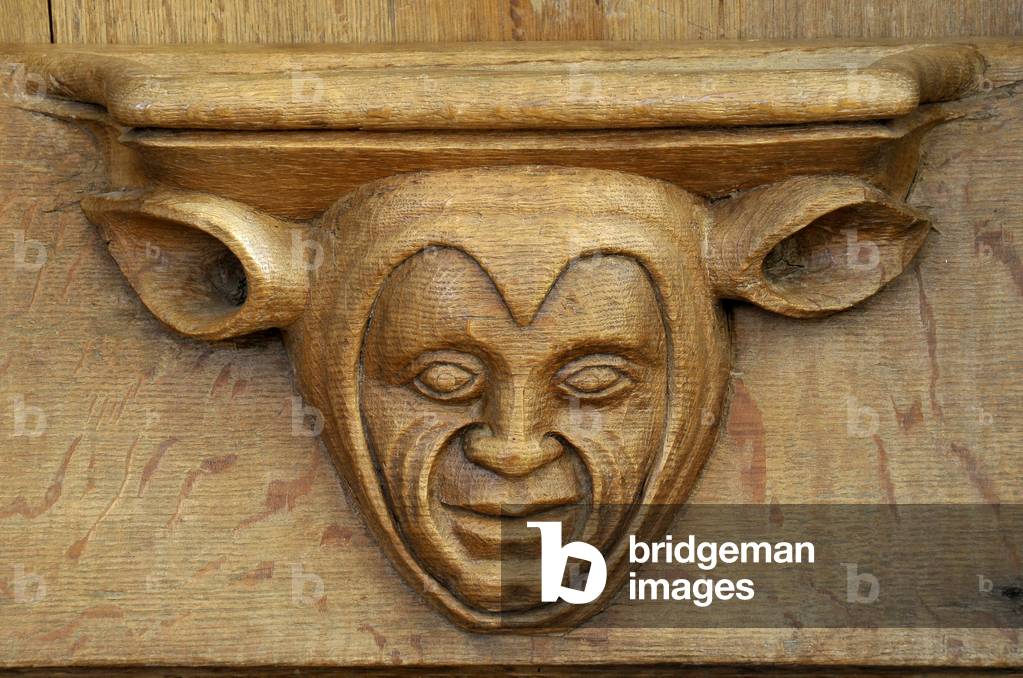 Evil face. 15th century stall adorned with Misericordes de l'abbey Saint Pierre (12th-18th century) in Chezal-Benoit (Chezal Benoit), Cher (18160), Centre, France. Photography 2010.