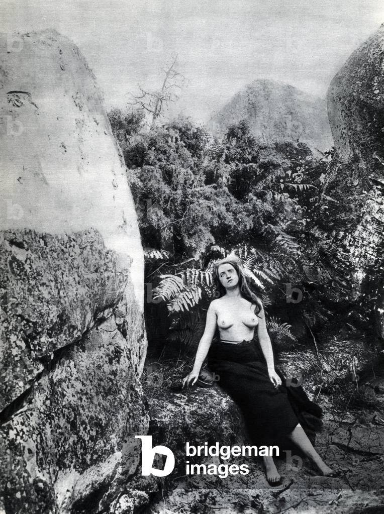 A naked young woman posing in a landscape around 1900 Anonymous photography