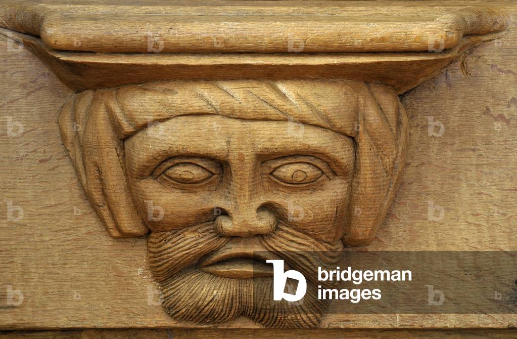 Male face. 15th century stall adorned with Misericordes de l'abbey Saint Pierre (12th-18th century) in Chezal-Benoit (Chezal Benoit), Cher (18160), Centre, France. Photography 2010.