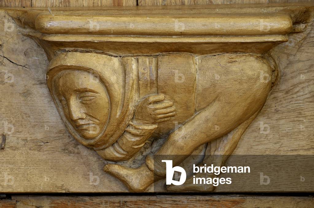 Male character. 15th century stall adorned with Misericordes de l'abbey Saint Pierre (12th-18th century) in Chezal-Benoit (Chezal Benoit), Cher (18160), Centre, France. Photography 2010.