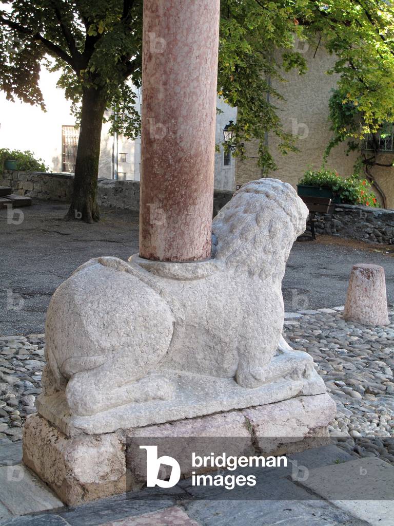 Detail of a lion sculpture at the foot of a column of the north porch of the Cathedrale Notre Dame du Real, 12th century, in Embrun (Hautes Alpes)