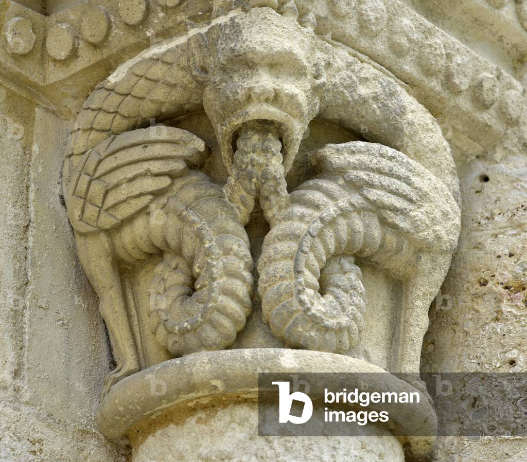 Romanesque art: marquee detail depicting monsters wings - Main facade of the church Notre Dame (Notre-Dame) of Surgeres (17700), Charente-Maritime
