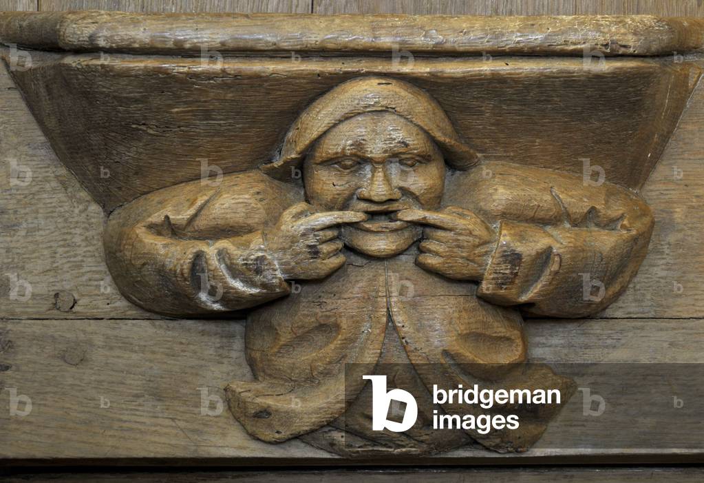 Man's face. 15th century stall adorned with Misericordes de l'abbey Saint Pierre (12th-18th century) in Chezal-Benoit (Chezal Benoit), Cher (18160), Centre, France. Photography 2010.