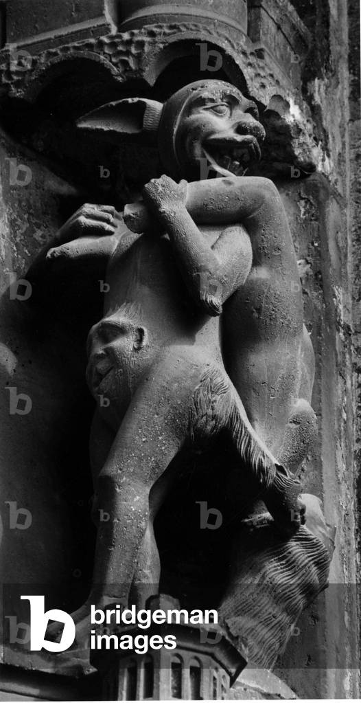 Gothic architecture: Detail of a column of the Cathedrale de Chartres (south portal, central bay). A demon carries a naked woman on her shoulders.