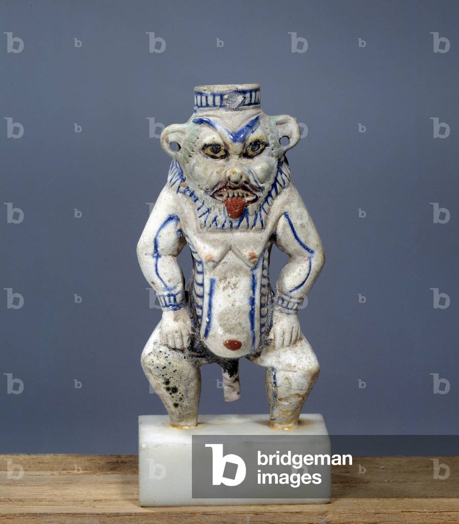 Egyptian antiquite: ceramic kohol bottle in the shape of the God Bes. Reg of Amenophis III (1391-1353) (ceramic)