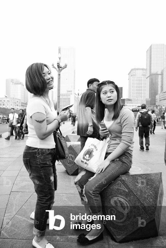 Young girls chatting in the main sq Chengdu, China (b/w photo)