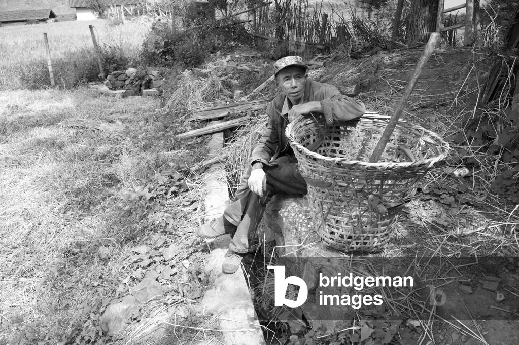 Man resting on Cheba, China (b/w photo)
