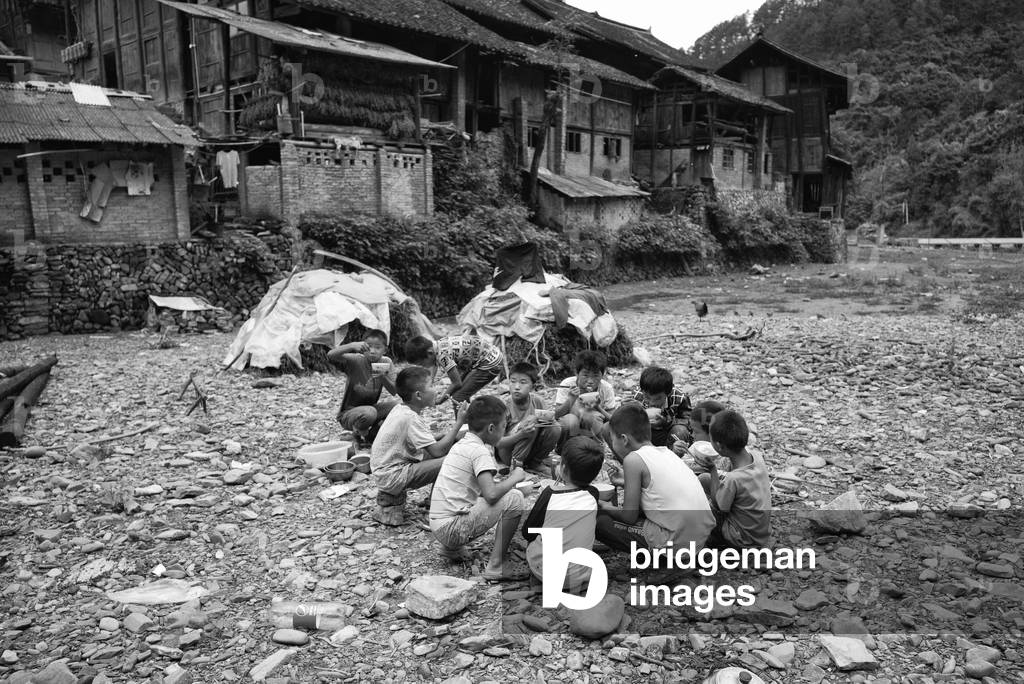 Kids play by river nr Yibin, China (b/w photo)