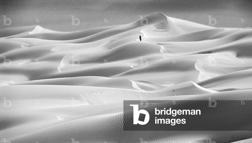 Walking across Sand Dunes, Morocco (b/w photo)
