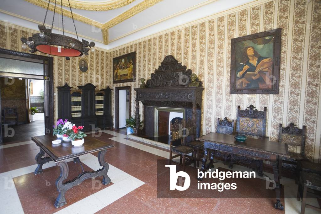 Early 20th century furnishings and ornate wooden fireplace in Casa Don Bosco or Casa de San Juan Bosco, Ronda, Malaga Province, Spain