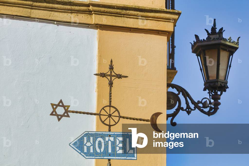 Sign with Islamic, Jewish and Christian symbols, Ronda, Spain (photo)