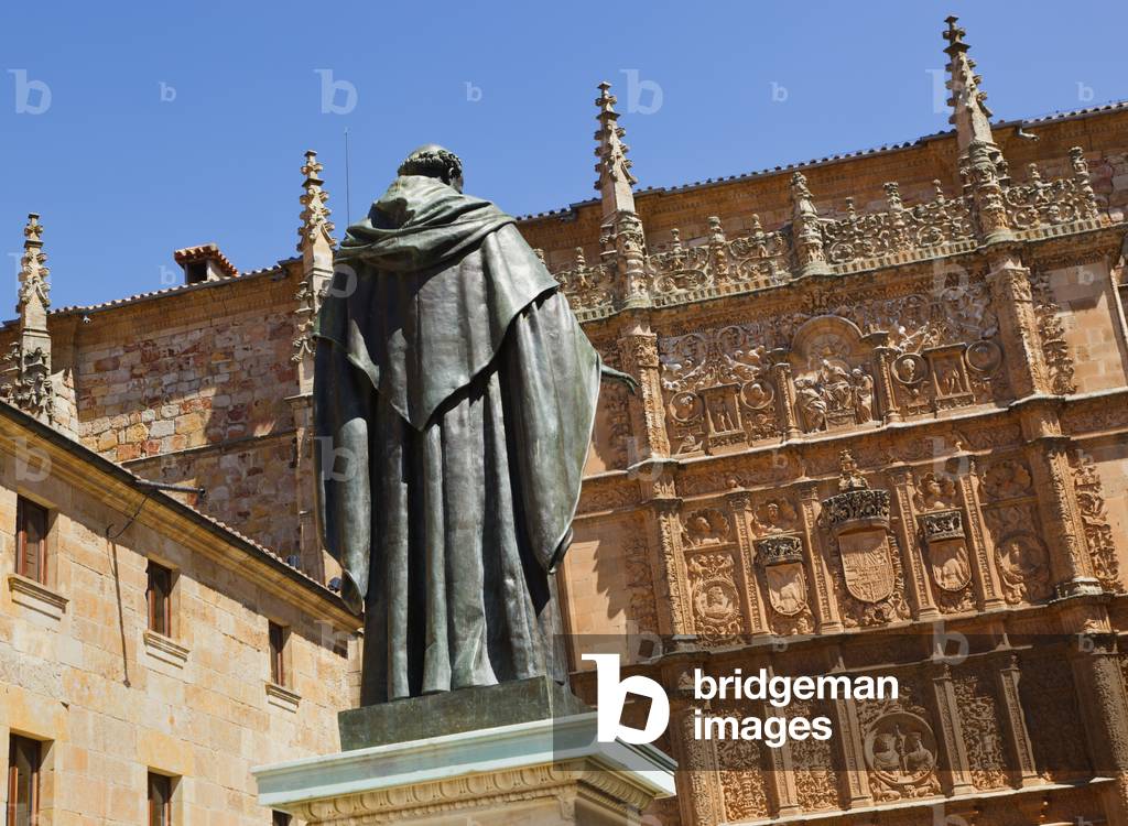 Salamanca, Salamanca Province, Spain.  Statue of Augustinian friar Fray Luis Ponce de León 1527   1591 by Nicasio Sevilla in front of the 16th century Plateresque entrance to the Escuelas Mayores or University building.  Fray Luis was a scholar, lecturer and lyric poet from the Spanish Golden Age. (photo)