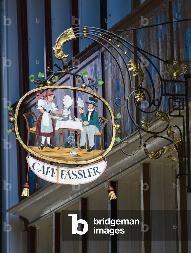 Appenzell, Appenzell Innerrhoden Canton, Switzerland.  Ironwork sign outside Cafe Fassler in Hauptegasse.