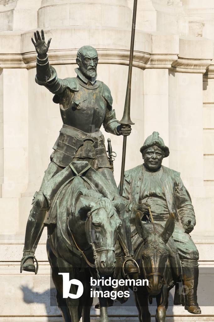 Madrid, Spain.  Monument to Cervantes in Plaza de España. Don Quijote riding his horse Rocinante, and Sancho Panza riding his donkey. (photo)
