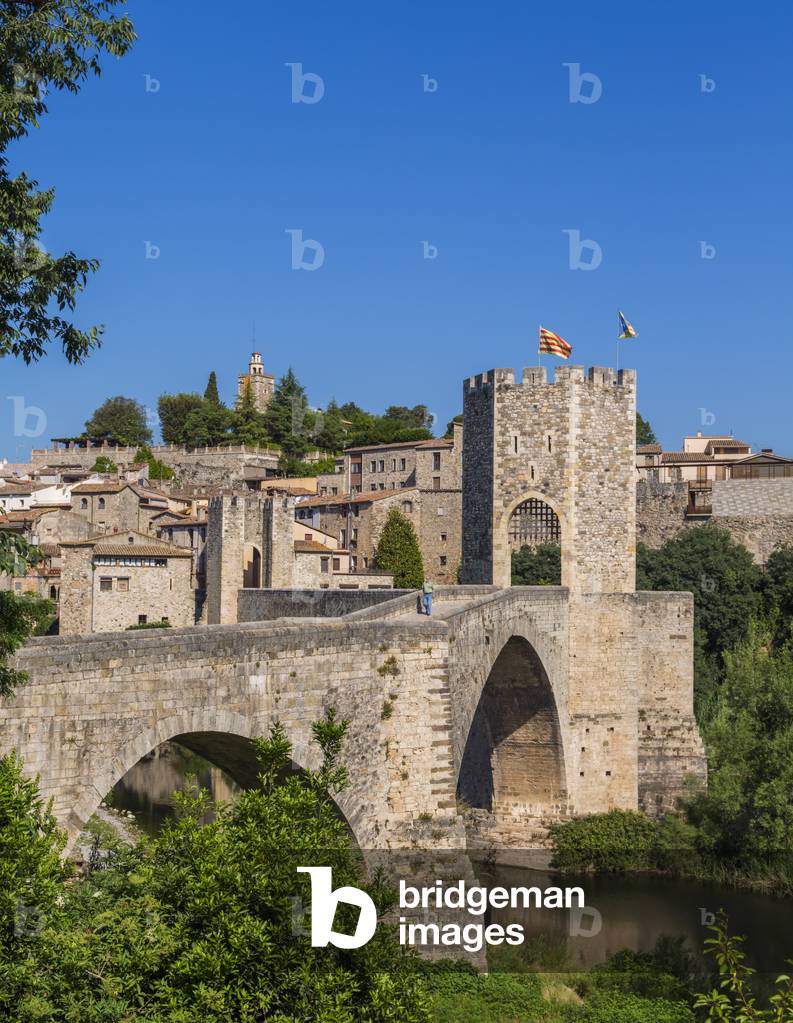 Besalu, Girona Province, Catalonia, Spain.  Fortified bridge known as El Pont Vell, the Old Bridge, crossing the Fluvia river. Documents dating back to the 11th century mention a bridge on this site. (photo)
