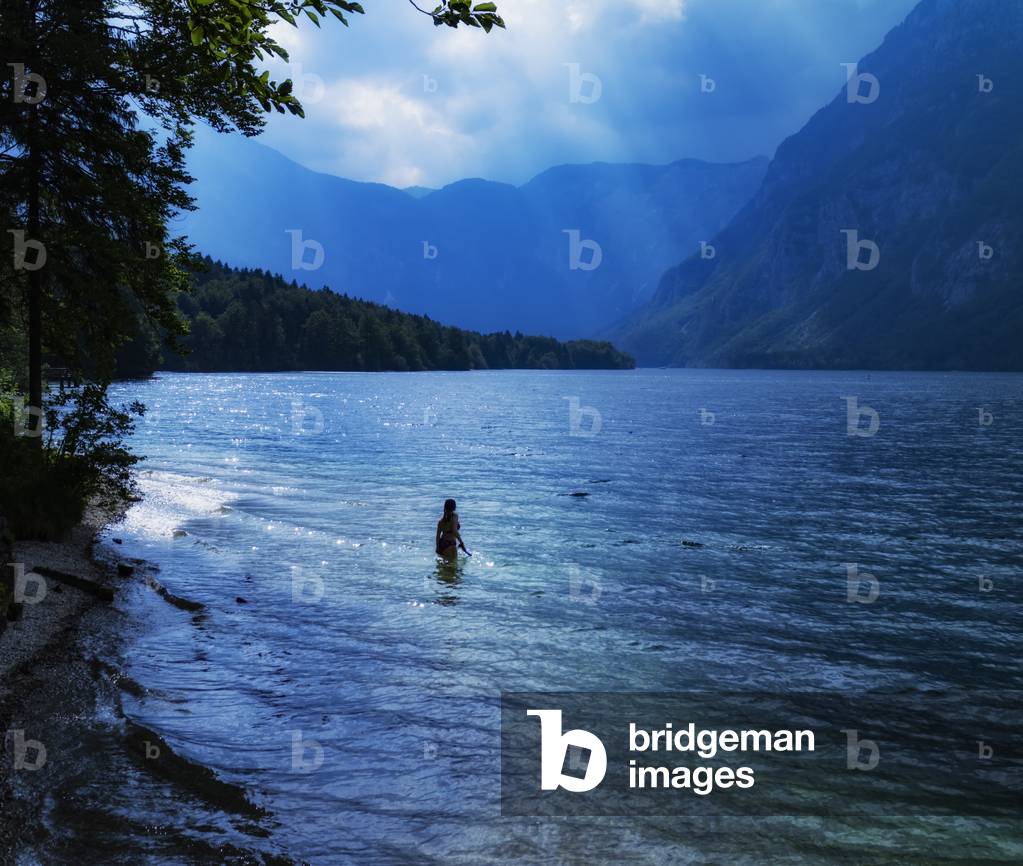 Swimmer entering the water in the late afternoon, Lake Bohinj (Bohinjsko jezero), Triglav National Park, Upper Carniola, Slovenia (photo)