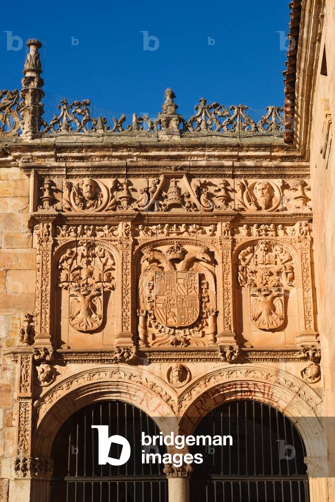 Salamanca, Salamanca Province, Spain. University. Imperial shields above the entrance to the Courtyard of the Escuelas Menores.  The centre shield is that of Carlos V.