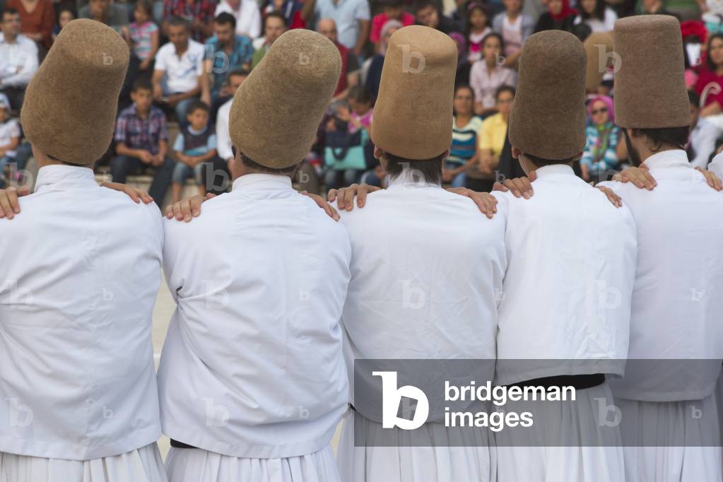 Konya, Konya Province, Turkey.   Whirling Dervishes.  Line of dancers in initial stage of ceremony.