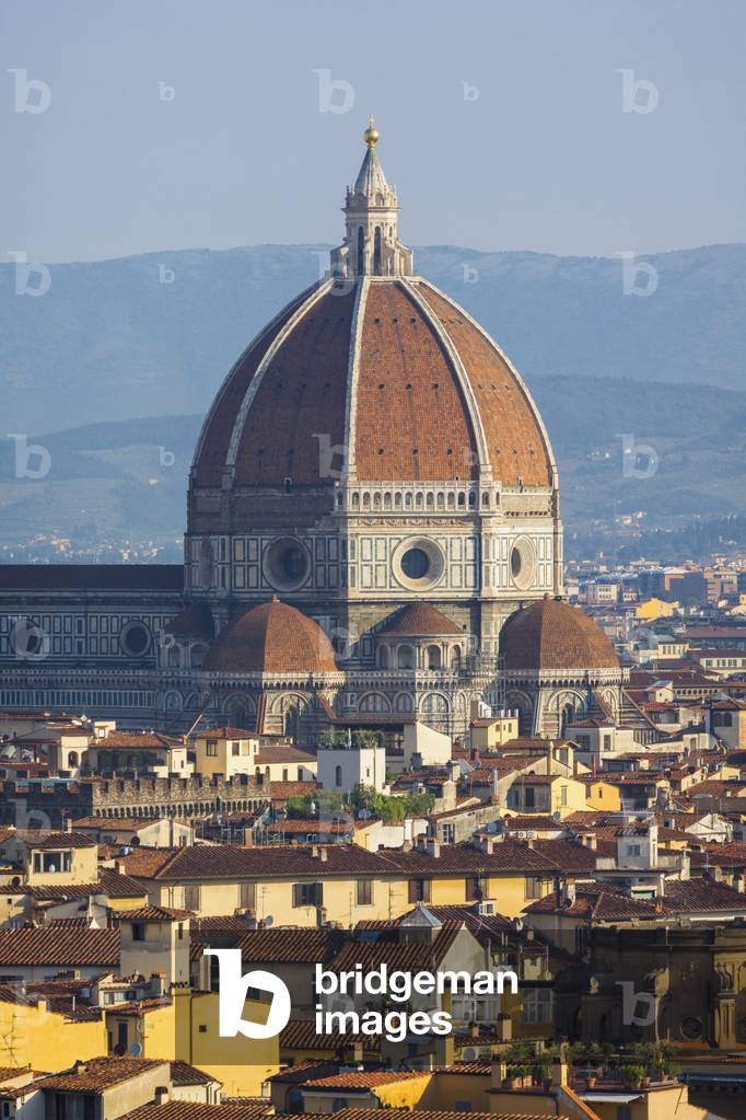 Florence, Tuscany, Italy.  View over the city to the dome of the Duomo - Cattedrale di Santa Maria del Fiore - from the Piazzale Michelangelo.  The dome is the work of Filippo Brunelleschi.  (photo)