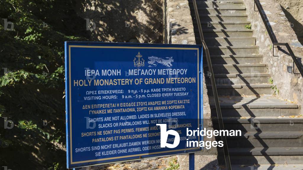 Sign showing clothing requirements to enter The Monastery of the Transfiguration or The Great Meteora, also known as The Holy Monastery of Great Meteoron, founded in the 14th century,Meteora, Thessaly, Greece (photo)