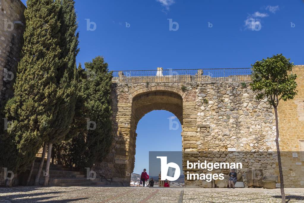 Antequera, Malaga Province, Andalusia, southern Spain.  Arco de los Gigantes (Arch of the Giants) seen from within the Alcazaba (citadel) walls. (photo)
