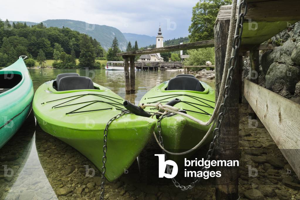Canoes for rent. The church of St. John (Cerkev sv Janeza) at Ribcev Laz in background, Lake Bohinj (Bohinjsko jezero), Triglav National Park, Upper Carniola, Slovenia (photo)