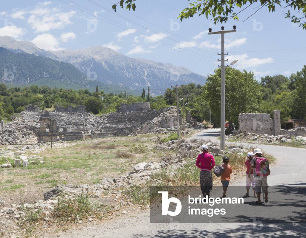 Tlos, Antalya Province, Turkey.  Ruins of the ancient city.  Children on road in front of theatre dating from Roman era.