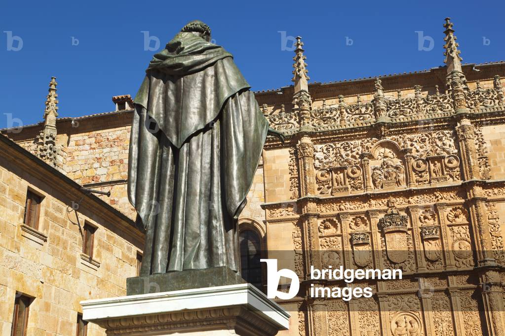 Salamanca, Salamanca Province, Spain.  Statue of Augustinian friar Fray Luis Ponce de León 1527   1591 by Nicasio Sevilla in front of the 16th century Plateresque entrance to the Escuelas Mayores or University building.  Fray Luis was a scholar, lecturer and lyric poet from the Spanish Golden Age. (photo)