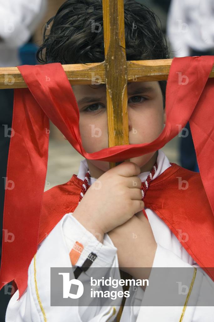 Boy in Holy Week costume with cross, Nerja, Costa del Sol, Malaga Province, Spain