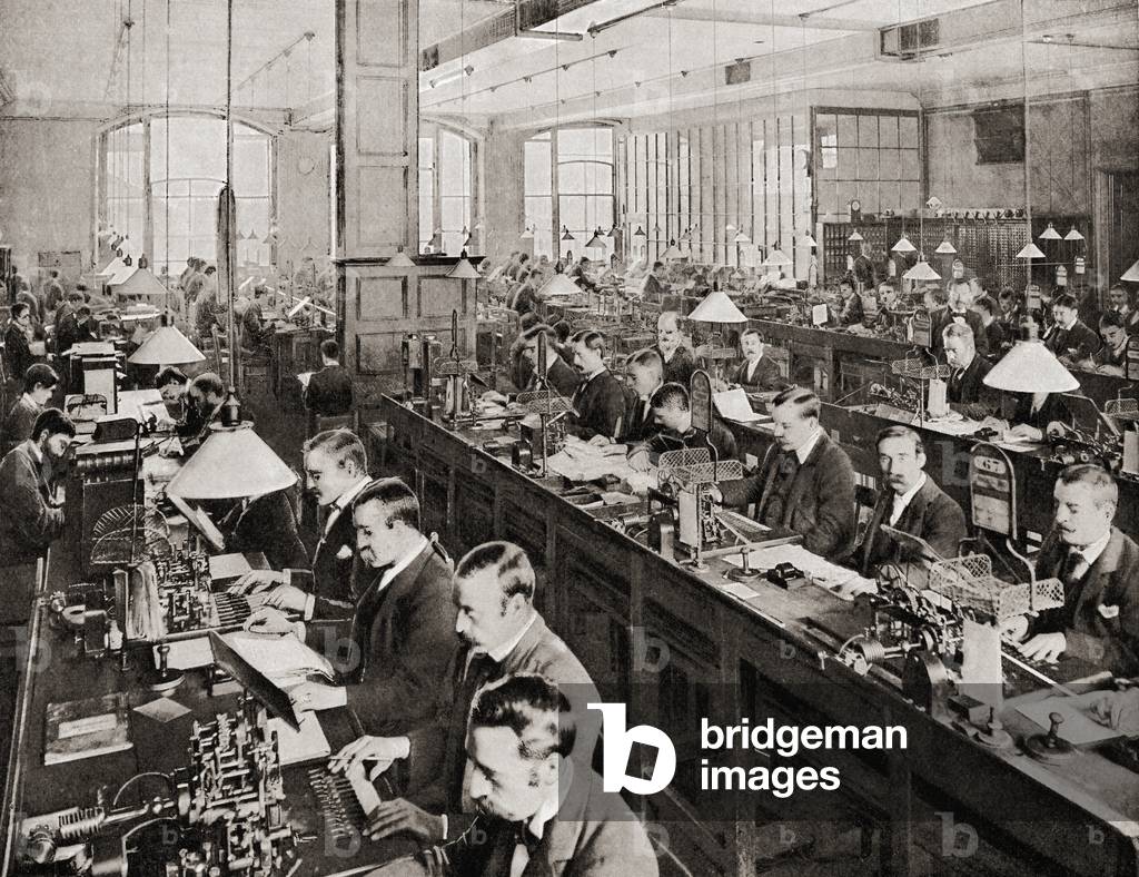 Men at work sending and receiving telegraph messages in the General Post Office's submarine cable room at St Martin's le Grand, London, England in the late 19th century.