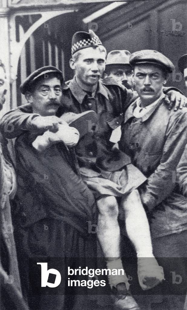Porters at Boulogne, France, carrying a Scots soldier who has been wounded in both feet during the First World War, from 'The Illustrated War News', published in 1914 (litho)