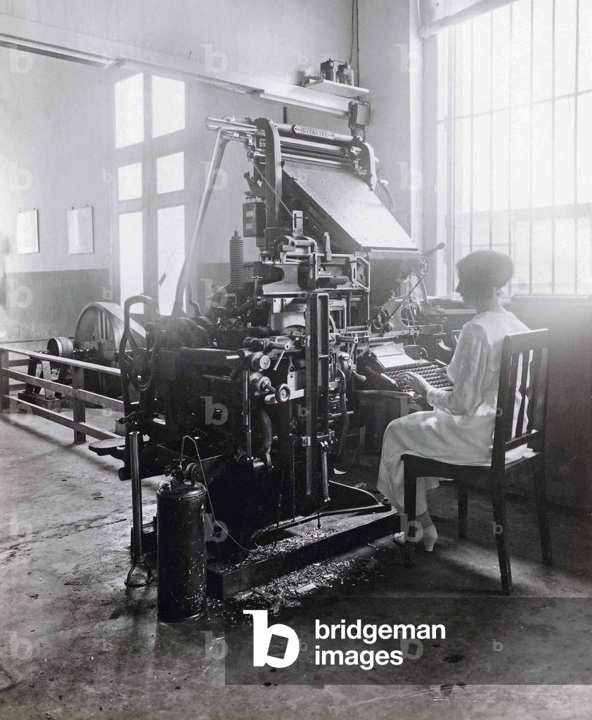 Woman working at a type-setting machine, c.1920