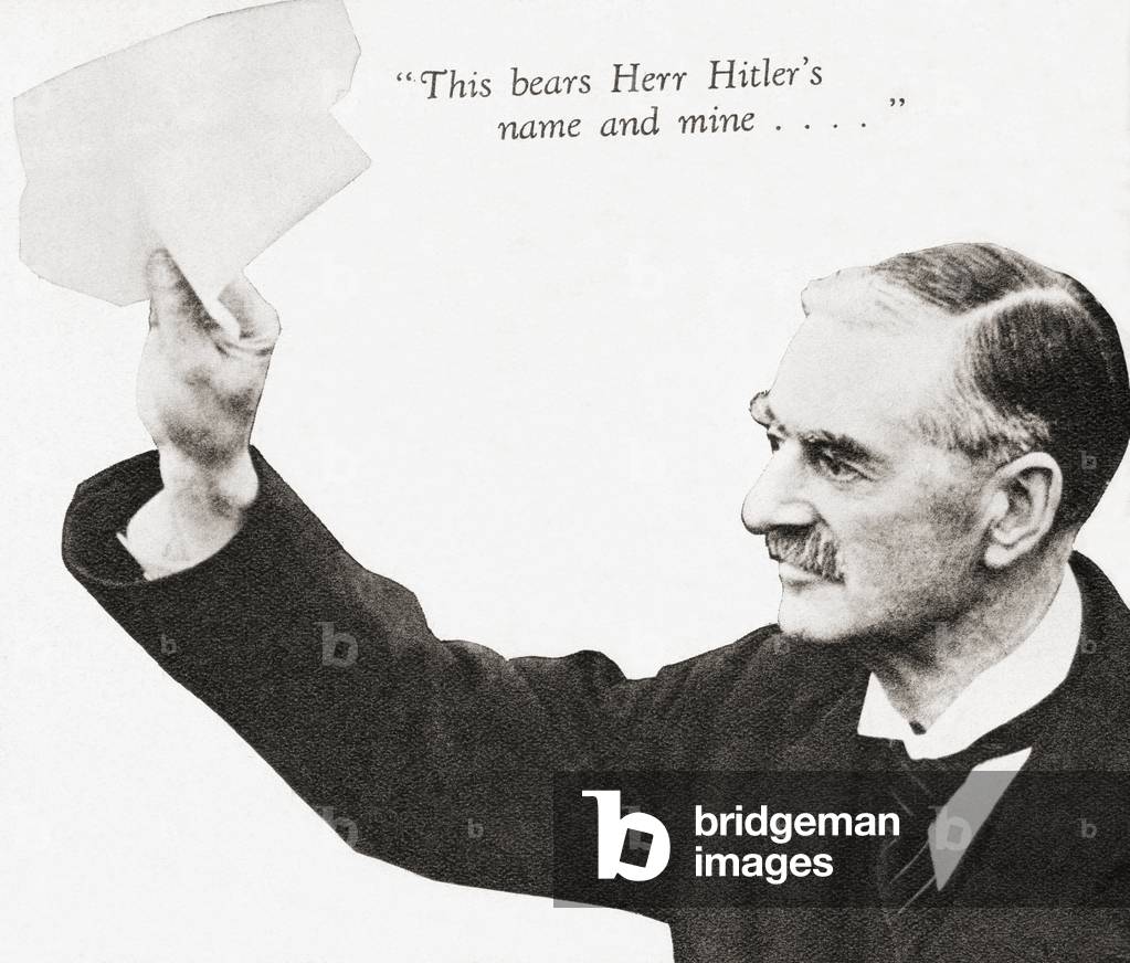 Neville Chamberlain holds the paper signed by both Hitler and himself on his return from Munich to Heston Aerodrome, after their meeting in September 1938.